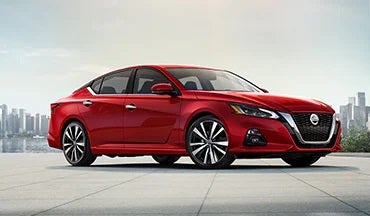 2023 Nissan Altima in red with city in background illustrating last year's 2022 model in Nissan City of Port Chester in Port Chester NY