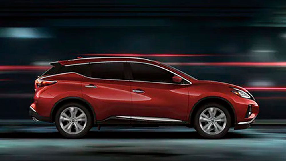 2023 Nissan Murano shown in profile driving down a street at night illustrating performance. | Nissan City of Port Chester in Port Chester NY